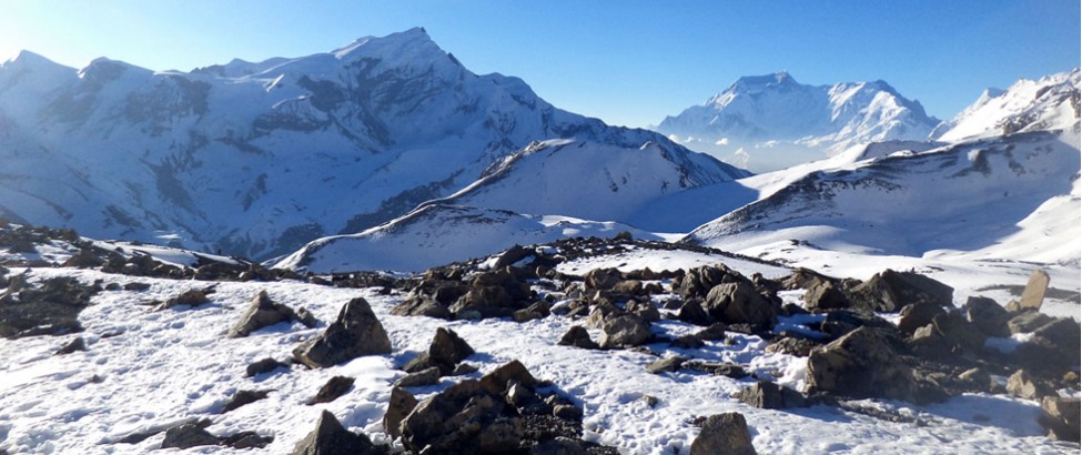 An illustration of the rough yet beautiful terrain of the Rupina La Pass Trek, with craggy mountain paths, deep blue skies, and a distant view of snow-capped peaks symbolizing the adventure and beauty of the journey.