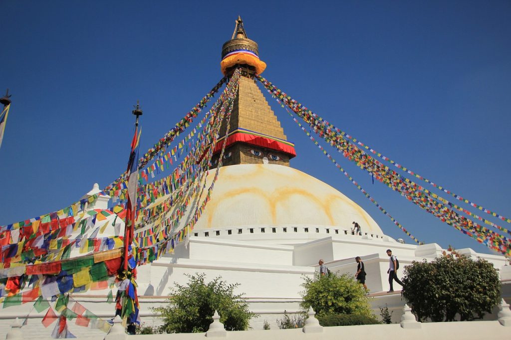 Boudhanath Stupa with prayer flags fluttering.