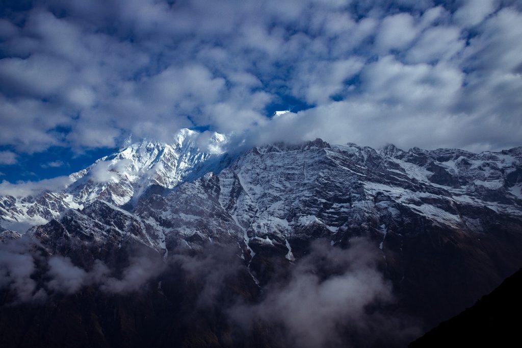 A breathtaking view of Mardi Himal, showcasing its snow-capped peaks against a clear blue sky.