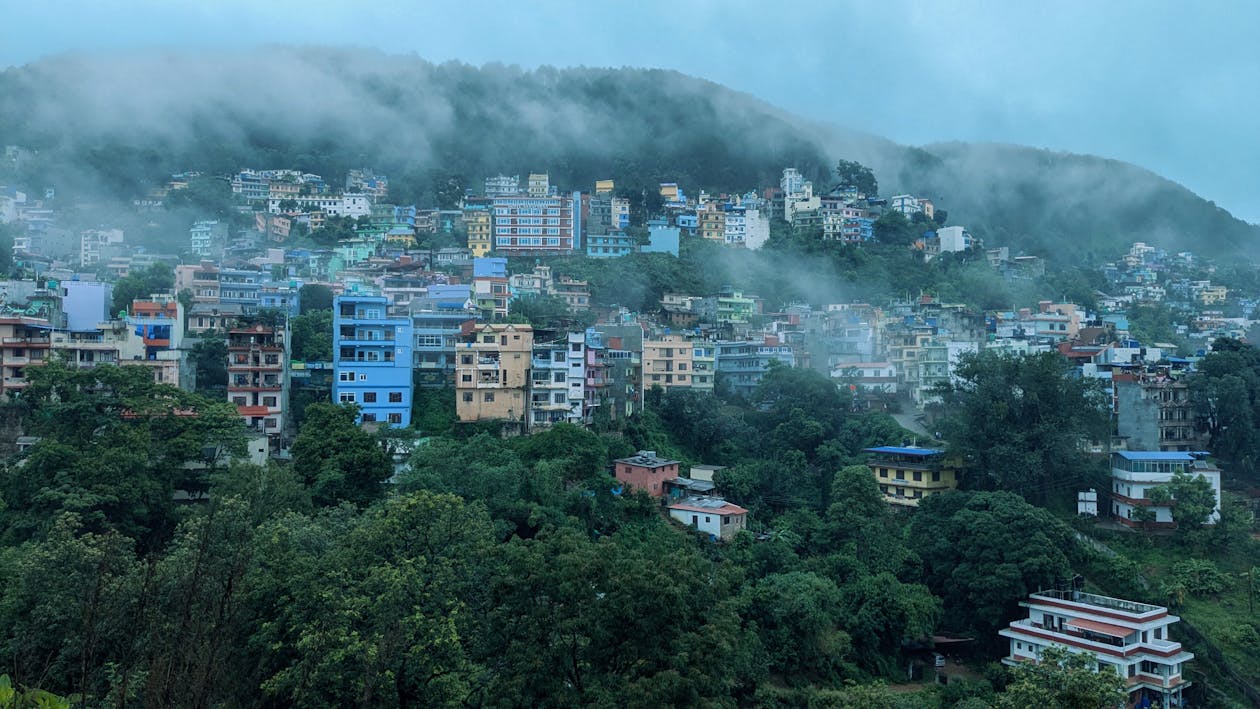 Lush green Palpa Hills are shrouded in fog during the rainy season, creating a serene and mystical landscape.