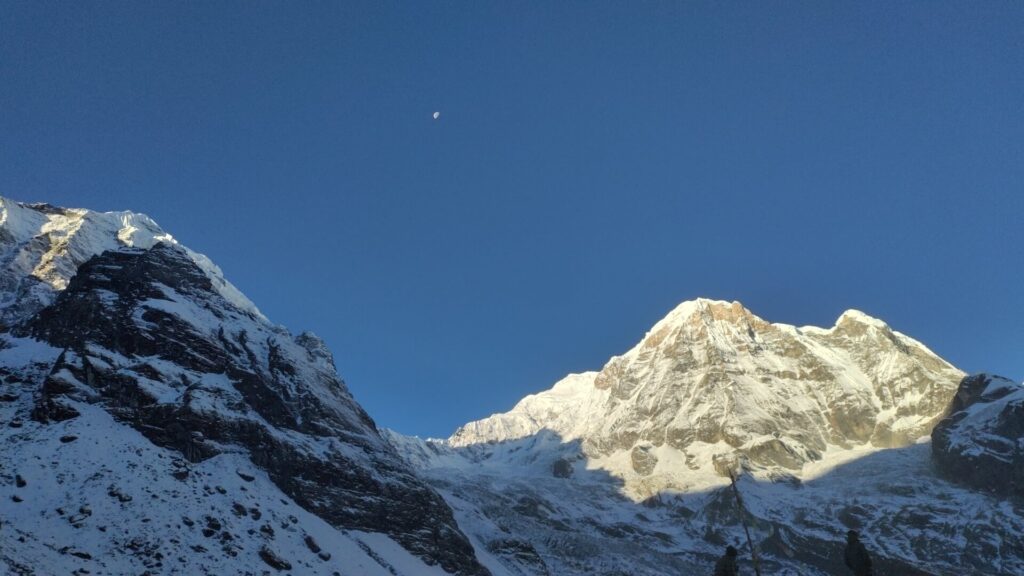 Sunrise over Annapurna I, with the mountain peaks bathed in the soft glow of early morning light.