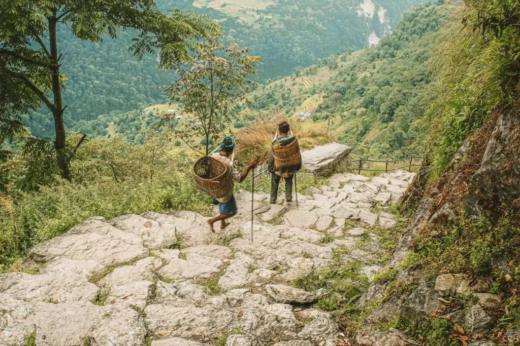 Locals descending the rugged stone staircase on the Manaslu Circuit
