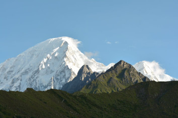 Panoramic view of the majestic Manaslu ranges, featuring towering snow-capped peaks under a clear blue sky, highlighting the grandeur of the Himalayas in Nepal.
