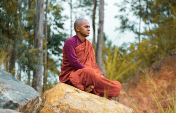 Monk is doing yoga inside the deep jungle of Nepal to relax and gain happiness.